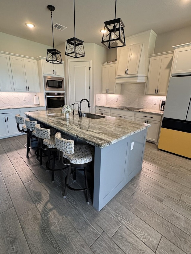 252 Harvard Ln, Springtown, TX 76082 - kitchen featuring stainless steel appliances, light wood-style flooring, backsplash, a large island with sink, and recessed lighting