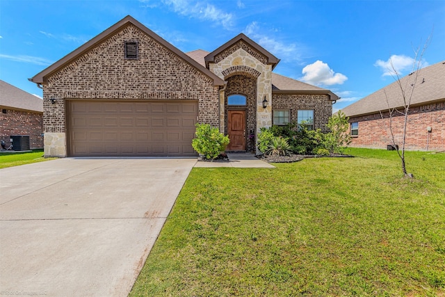 623 Comal Dr, Crandall, TX 75114 - french provincial home with central air condition unit, concrete driveway, a front yard, an attached garage, and brick siding