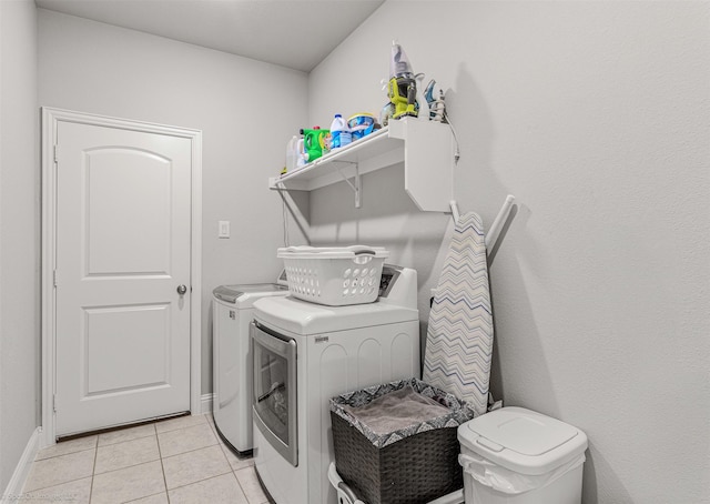 623 Comal Dr, Crandall, TX 75114 - laundry area featuring washer and dryer, light tile patterned flooring, and baseboards