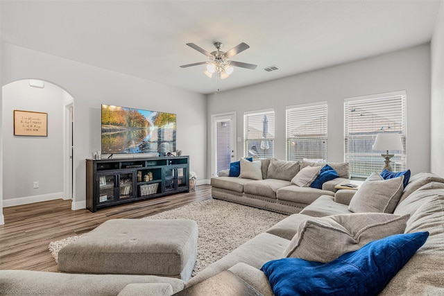 623 Comal Dr, Crandall, TX 75114 - living room featuring arched walkways, a ceiling fan, wood finished floors, and baseboards