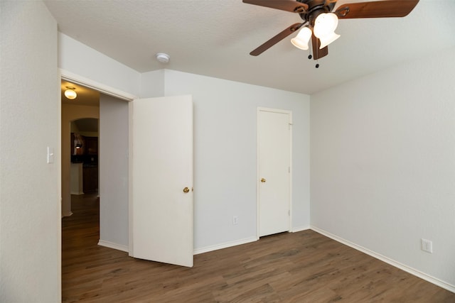 4541 Grainland Ct, Fort Worth, TX 76179 - unfurnished bedroom with wood finished floors, arched walkways, and baseboards