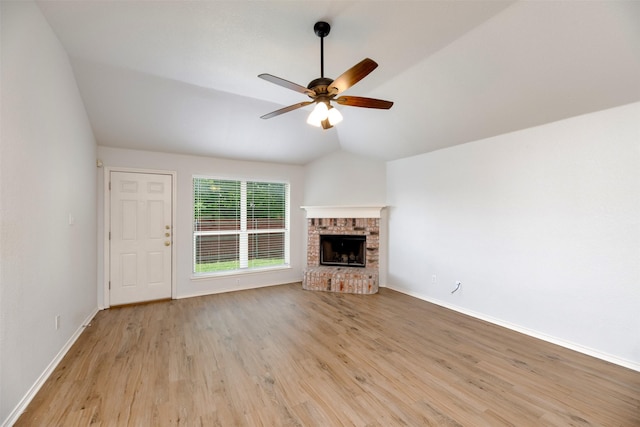 4541 Grainland Ct, Fort Worth, TX 76179 - unfurnished living room with a ceiling fan, light wood-style flooring, a fireplace, vaulted ceiling, and baseboards