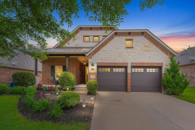 5604 Ridgeson Dr, Mckinney, TX 75071 - view of front of property with a standing seam roof, driveway, covered porch, a garage, and brick siding