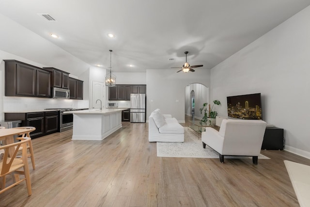 5604 Ridgeson Dr, Mckinney, TX 75071 - living area with arched walkways, light wood-style flooring, baseboards, recessed lighting, and a ceiling fan