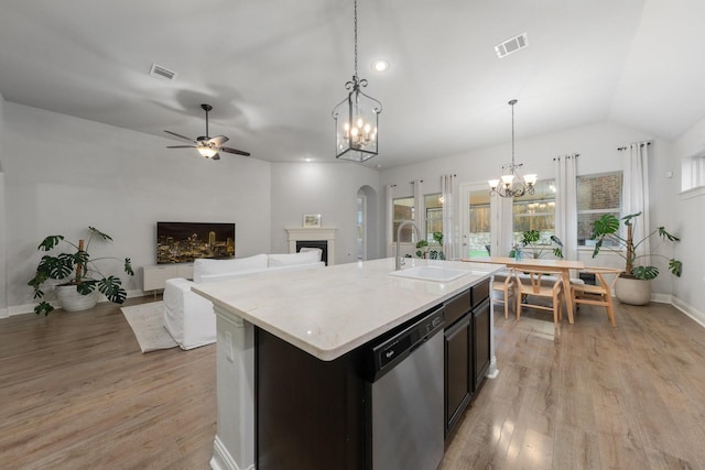 5604 Ridgeson Dr, Mckinney, TX 75071 - kitchen with a sink, dishwasher, a chandelier, light wood-type flooring, and arched walkways