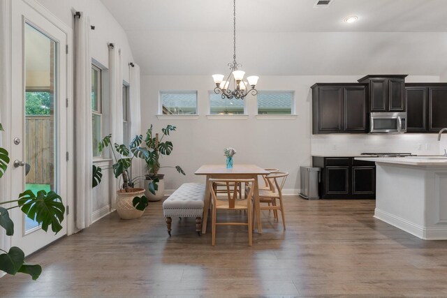 5604 Ridgeson Dr, Mckinney, TX 75071 - dining area with healthy amount of natural light, a chandelier, light wood-style floors, lofted ceiling, and baseboards