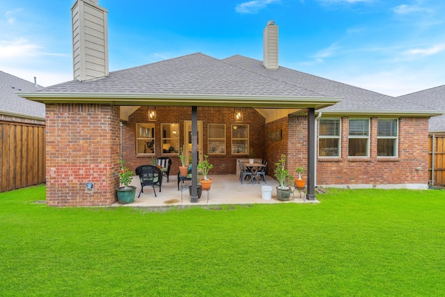 5604 Ridgeson Dr, Mckinney, TX 75071 - back of property featuring a chimney, brick siding, a shingled roof, and a patio