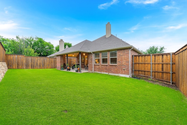 5604 Ridgeson Dr, Mckinney, TX 75071 - back of house with a chimney, brick siding, a patio, and a shingled roof
