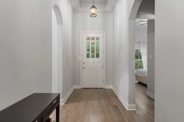 5604 Ridgeson Dr, Mckinney, TX 75071 - doorway featuring light wood-style floors, arched walkways, baseboards, and a ceiling fan