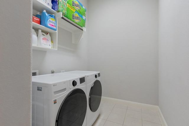 5604 Ridgeson Dr, Mckinney, TX 75071 - laundry area featuring washer and dryer, light tile patterned floors, and baseboards
