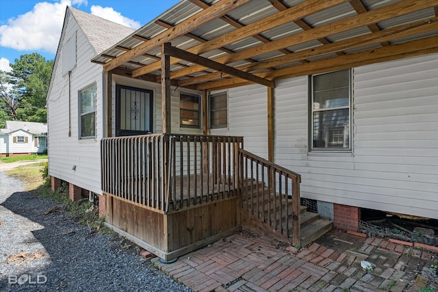 property entrance with a shingled roof