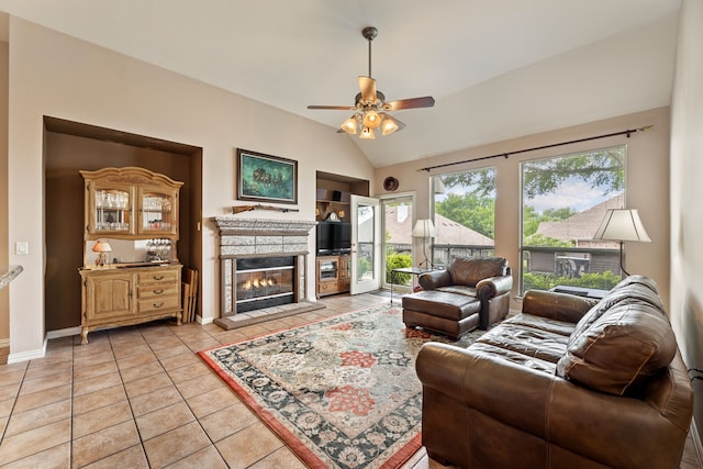 1453 Cattle Baron Ct, Fairview, TX 75069 - living room with lofted ceiling, ceiling fan, a glass covered fireplace, light tile patterned floors, and baseboards