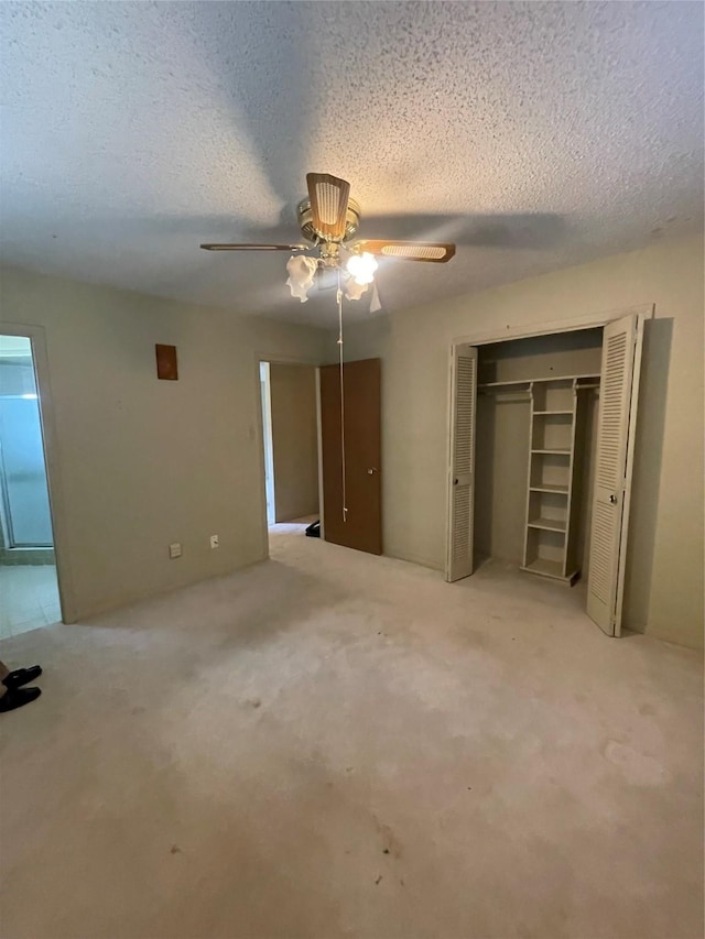 905 Seymore Cir, Denison, TX 75020 - unfurnished bedroom featuring a textured ceiling, a closet, carpet, and a ceiling fan
