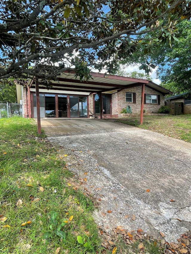 905 Seymore Cir, Denison, TX 75020 - view of front of house with concrete driveway, a carport, and fence