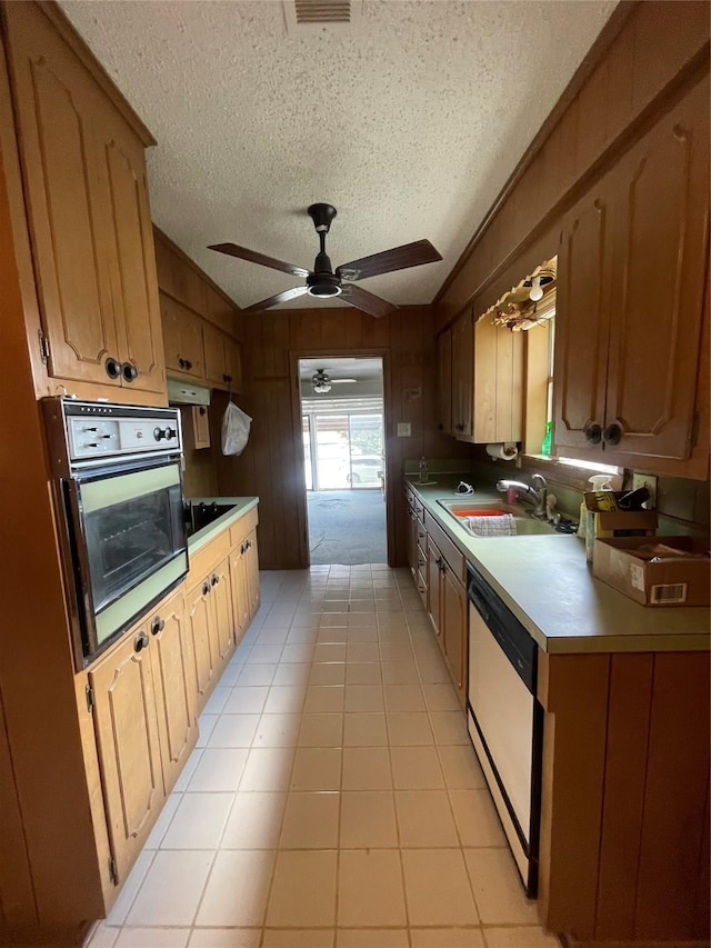 905 Seymore Cir, Denison, TX 75020 - kitchen featuring oven, white dishwasher, a sink, black electric stovetop, and a textured ceiling
