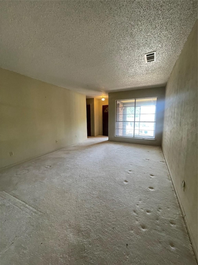 905 Seymore Cir, Denison, TX 75020 - carpeted spare room featuring a textured ceiling