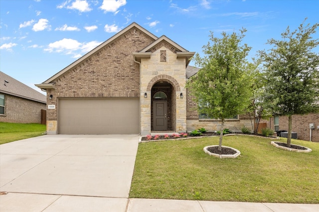 view of front of property with an attached garage, driveway, stone siding, a front yard, and brick siding