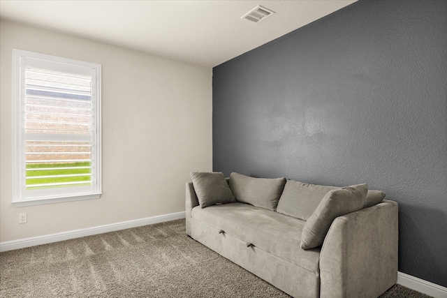 living area featuring baseboards and carpet flooring