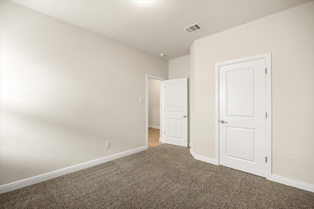 unfurnished bedroom with carpet flooring and baseboards