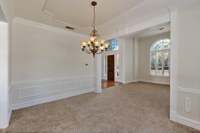 unfurnished dining area featuring a chandelier, carpet, and ornamental molding