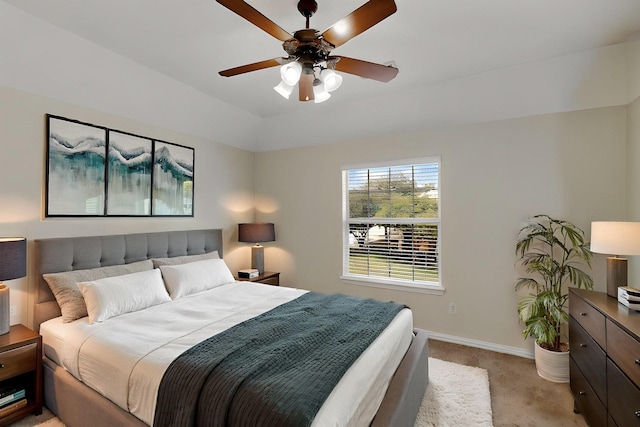 bedroom with light carpet, baseboards, and ceiling fan