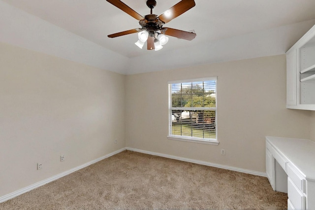 unfurnished dining area with light colored carpet, baseboards, and ceiling fan