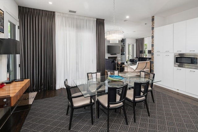 5811 Meletio Ln, Dallas, TX 75230 - dining room with dark wood-style flooring, a chandelier, and recessed lighting