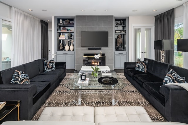5811 Meletio Ln, Dallas, TX 75230 - living room featuring french doors, built in features, and a tiled fireplace