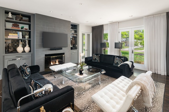 5811 Meletio Ln, Dallas, TX 75230 - living area featuring wood finished floors, built in features, a large fireplace, and french doors
