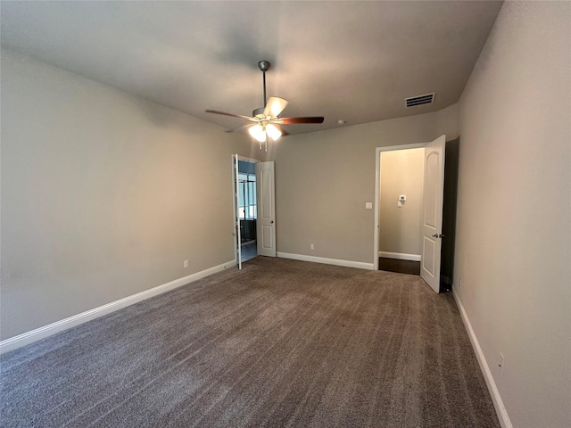 carpeted spare room with ceiling fan and baseboards