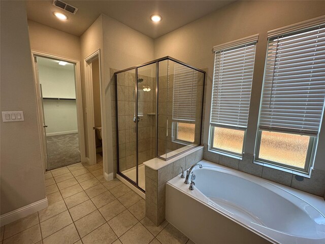 full bathroom with a shower stall, a garden tub, tile patterned floors, baseboards, and recessed lighting