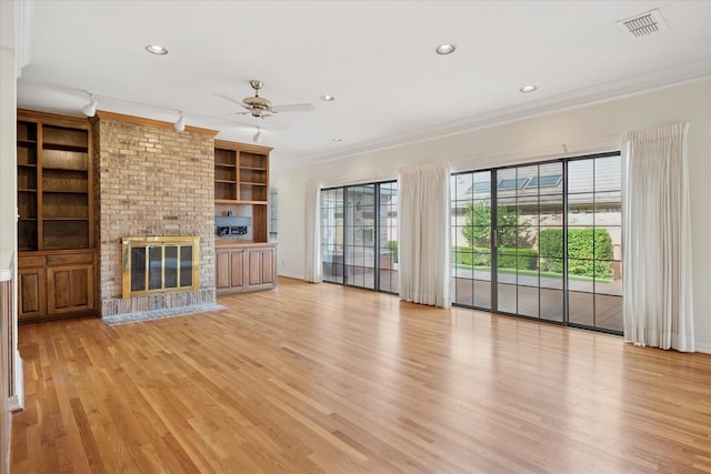 1817 Crockett Cir, Irving, TX 75038 - unfurnished living room featuring ornamental molding, light wood-type flooring, a ceiling fan, a fireplace, and recessed lighting