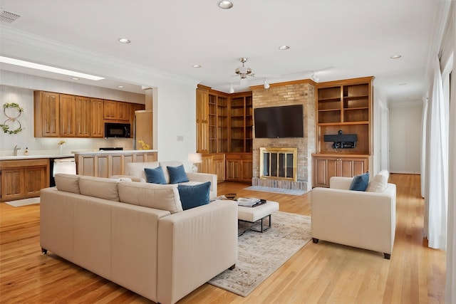 1817 Crockett Cir, Irving, TX 75038 - living area with ornamental molding, recessed lighting, a fireplace, and light wood-style flooring