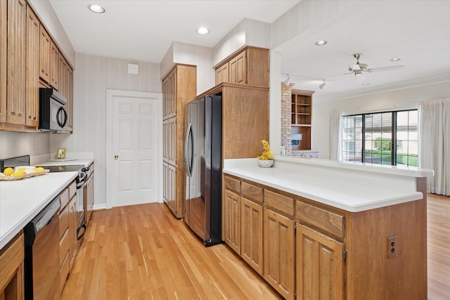 1817 Crockett Cir, Irving, TX 75038 - kitchen featuring freestanding refrigerator, black microwave, stainless steel dishwasher, a peninsula, and light countertops