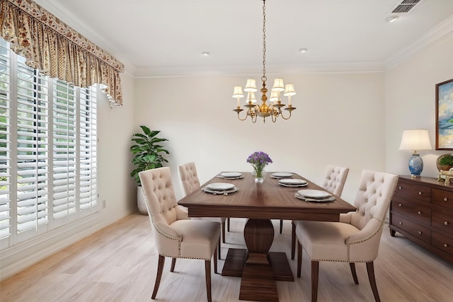 1817 Crockett Cir, Irving, TX 75038 - dining area with a chandelier, light wood-type flooring, crown molding, and baseboards