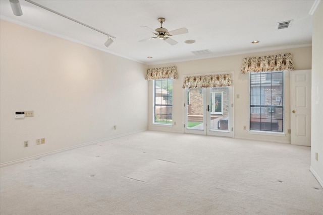 1817 Crockett Cir, Irving, TX 75038 - carpeted spare room featuring crown molding, a ceiling fan, healthy amount of natural light, baseboards, and rail lighting