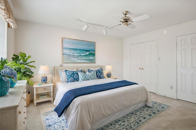 1817 Crockett Cir, Irving, TX 75038 - bedroom featuring track lighting, light carpet, a ceiling fan, and a closet