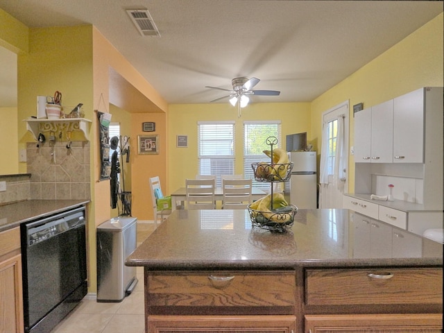 8614 Mountain Blf, Dallas, TX 75227 - kitchen featuring black dishwasher, freestanding refrigerator, light tile patterned flooring, ceiling fan, and tasteful backsplash