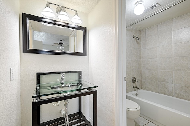 full bath featuring a sink, toilet, a textured wall, shower / tub combination, and a textured ceiling