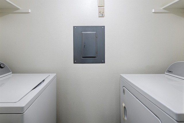 laundry room with washing machine and dryer and electric panel