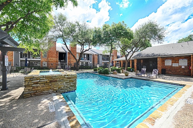 community pool featuring a residential view and fence