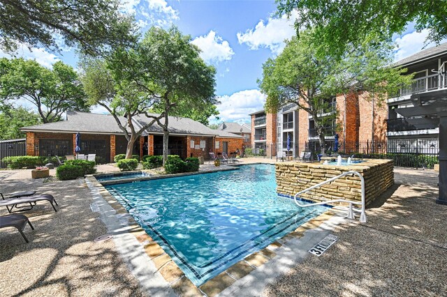 community pool featuring fence and a patio area