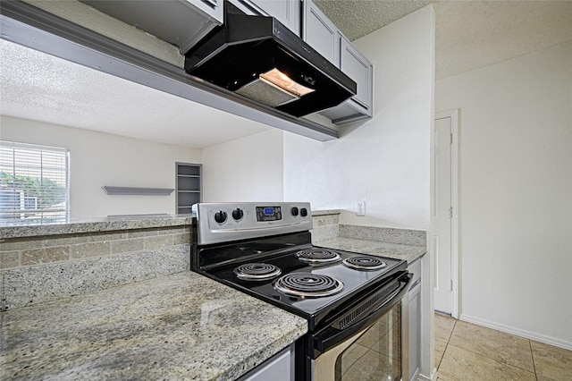 kitchen with stainless steel range with electric cooktop and a textured ceiling