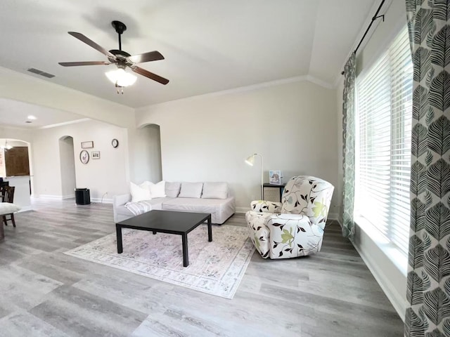 7500 W Fork Ln, Mckinney, TX 75071 - living area featuring arched walkways, plenty of natural light, baseboards, wood finished floors, and ornamental molding