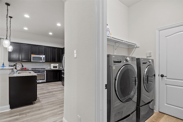 7500 W Fork Ln, Mckinney, TX 75071 - washroom with washer and dryer, a sink, light wood-type flooring, and recessed lighting