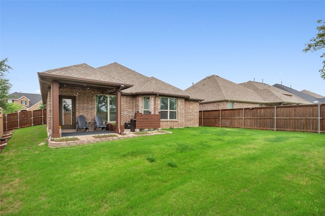 7500 W Fork Ln, Mckinney, TX 75071 - rear view of property with brick siding, a patio, and roof with shingles