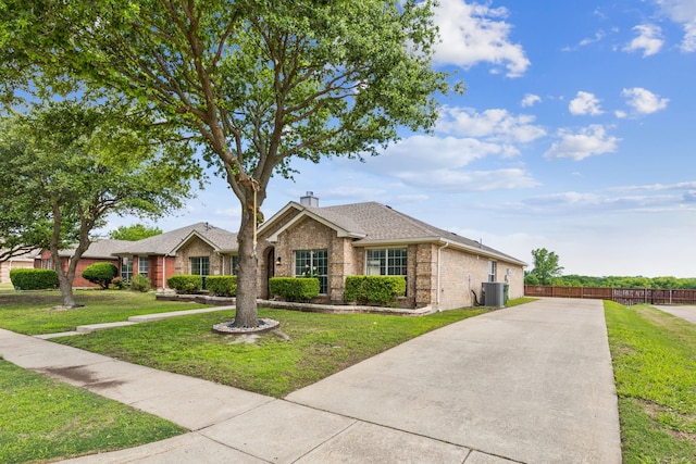 549 Seminole Trl, Murphy, TX 75094 - view of front of home with brick siding, a chimney, and roof with shingles