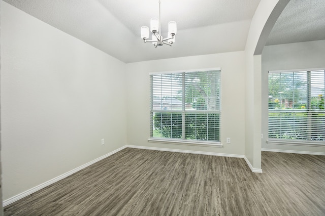 549 Seminole Trl, Murphy, TX 75094 - unfurnished room featuring wood finished floors, healthy amount of natural light, baseboards, and a chandelier