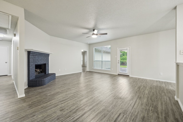 549 Seminole Trl, Murphy, TX 75094 - unfurnished living room featuring a ceiling fan, a fireplace, dark wood finished floors, baseboards, and a textured ceiling