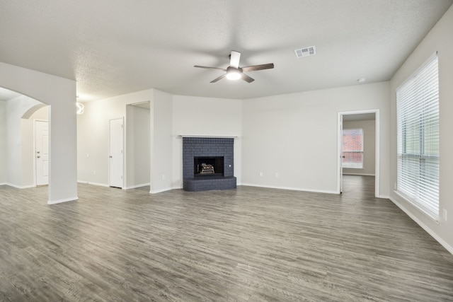 549 Seminole Trl, Murphy, TX 75094 - unfurnished living room with ceiling fan, wood finished floors, plenty of natural light, and a textured ceiling